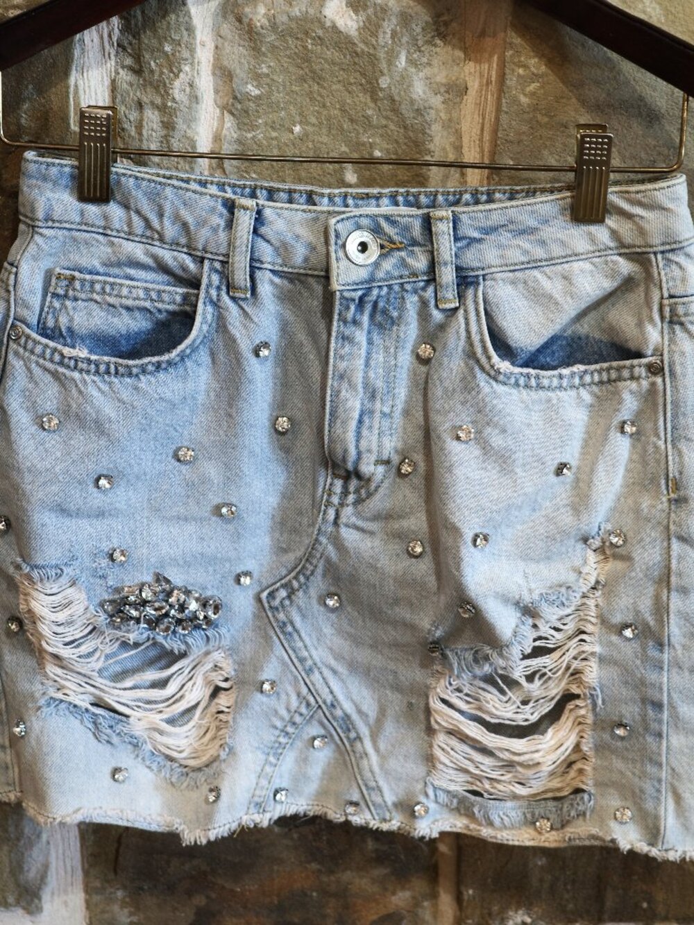 Denim jean mini skirt light wash distressed with scattered rhinestones ripped